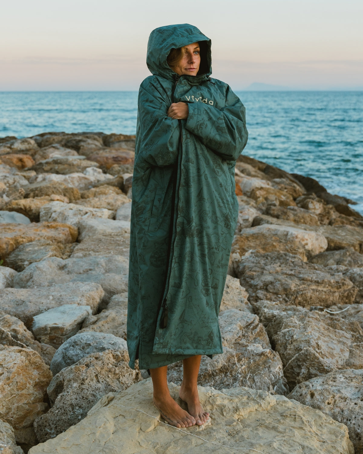 Lead_women2 - Woman wearing a Vivida sherpa weatherproof changing robe Green Map of Dreams