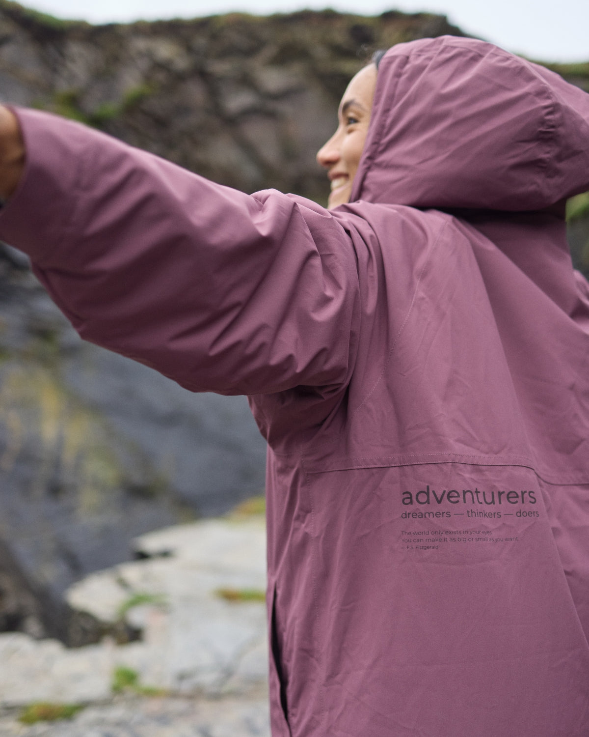 Woman wearing a Vivida sherpa weatherproof changing robe Purple Dusky Damson