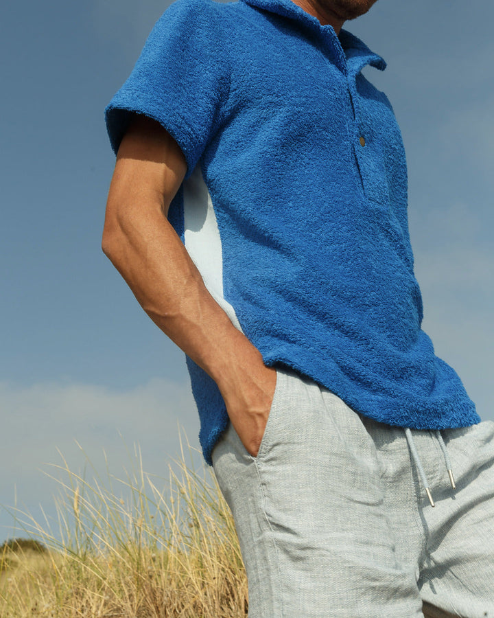 So English Brighton Blue Bond polo shirt, made in the UK, featuring a classic fit and vibrant blue color, displayed on a plain background.