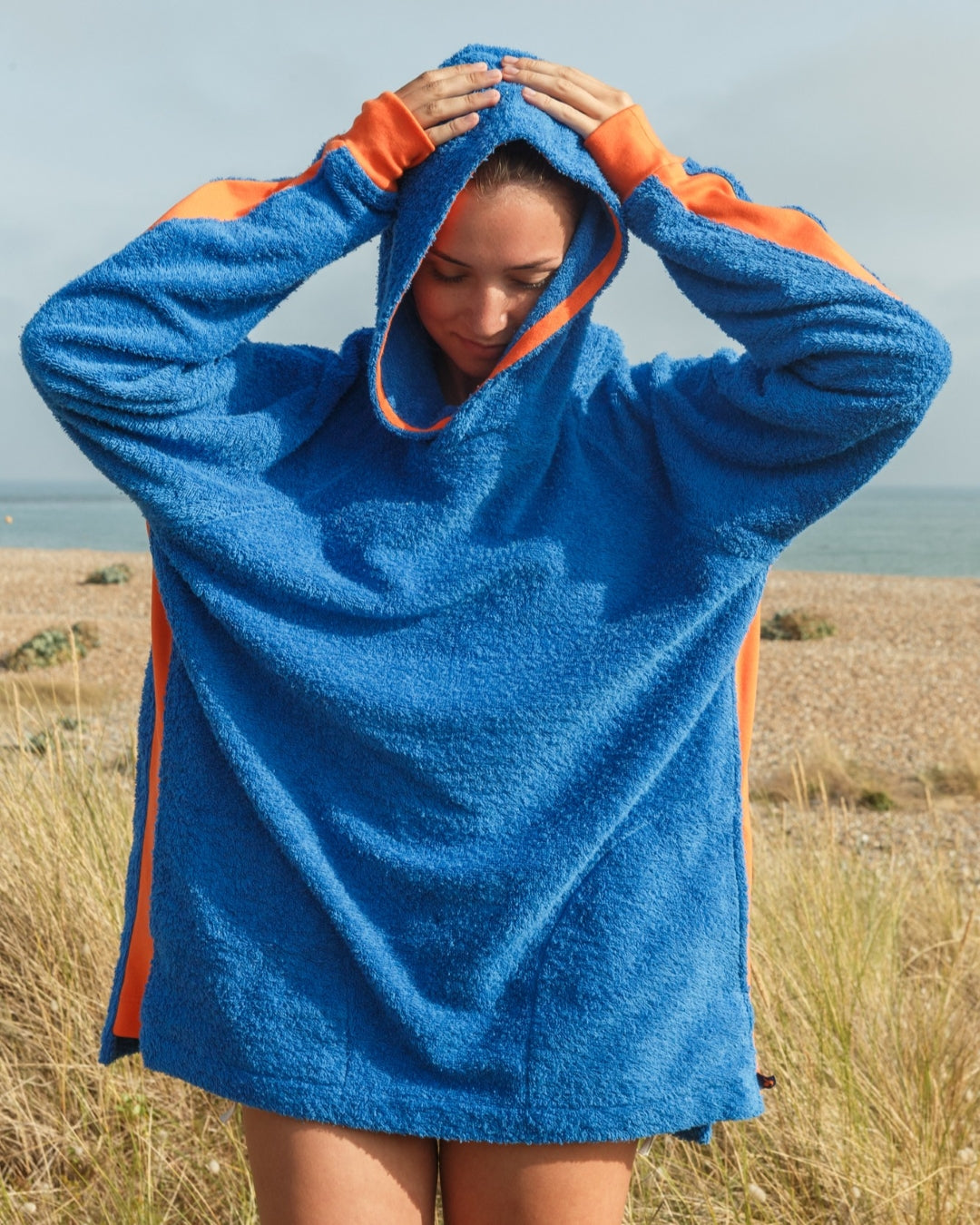 So English Hampstead hoodie in Brighton Blue and Orange with a beach-themed design, made in the UK.