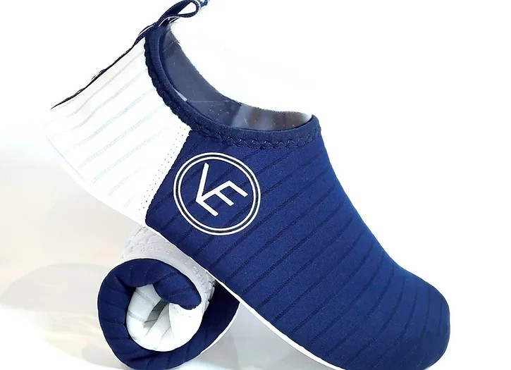 Side flat shot of the VE Shoe navy and white water shoe with a white sole and VE Shoes logo on the side.