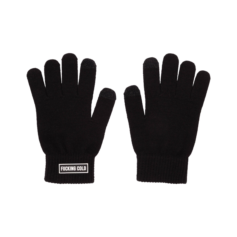 A pair of black knit gloves shown flat against a solid white background, with one glove displaying a white rectangular patch that reads 'FUCKING COLD' in white text.