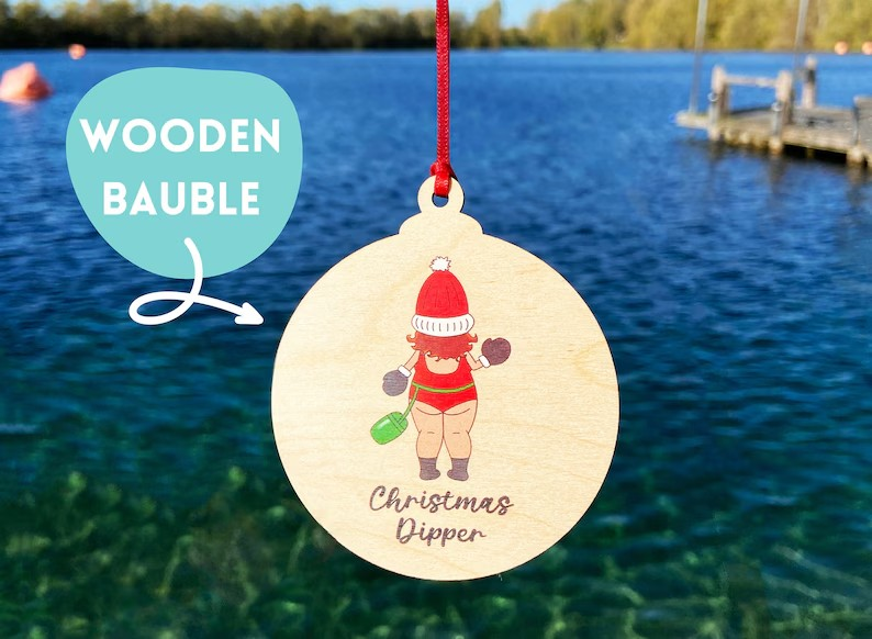 Wooden Christmas bauble featuring a wild swimmer in Santa hat and swimsuit with the text 'Christmas Dipper' - fun festive Christmas tree decoration for open water swimmers.