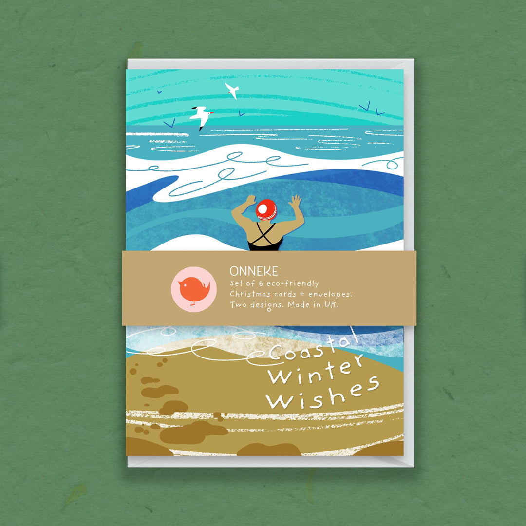 Onneke Coastal Winter Wishes pack of six Christmas cards with illustrated sea swimming design, white envelopes and paper belly band