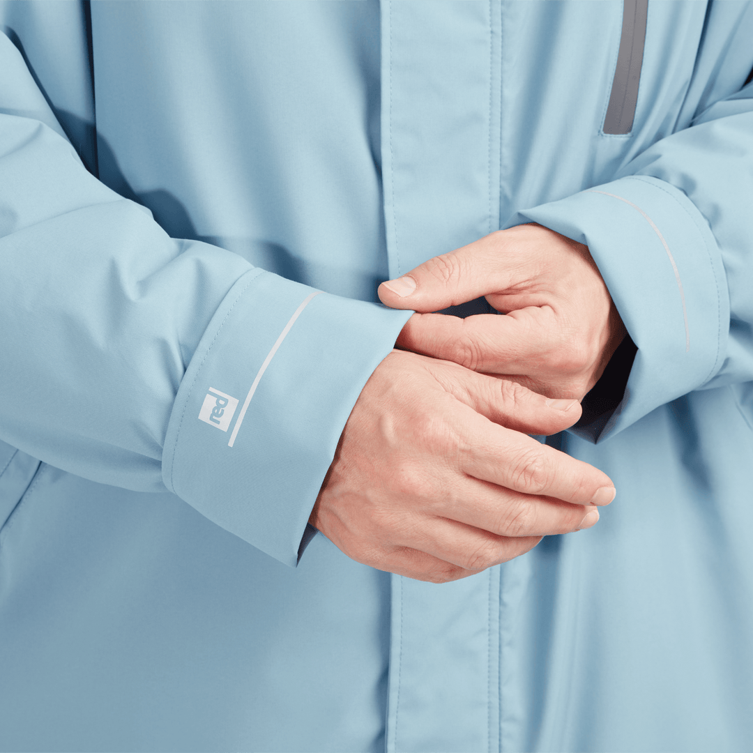 Adjustable cuff detail on Red Alter Evo men’s long sleeve waterproof changing robe in Alpine Blue.