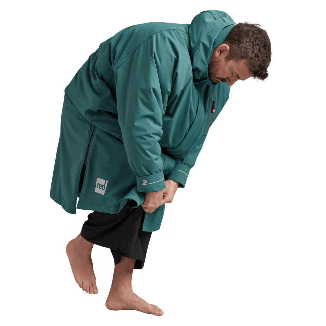 Side profile of a man changing underneath the Red Alter Evo long sleeve waterproof changing robe in Deep Teal.