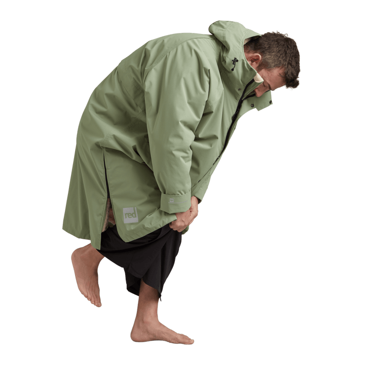 Side profile of a man changing underneath the Red Alter Evo long sleeve waterproof changing robe in Sage Green.