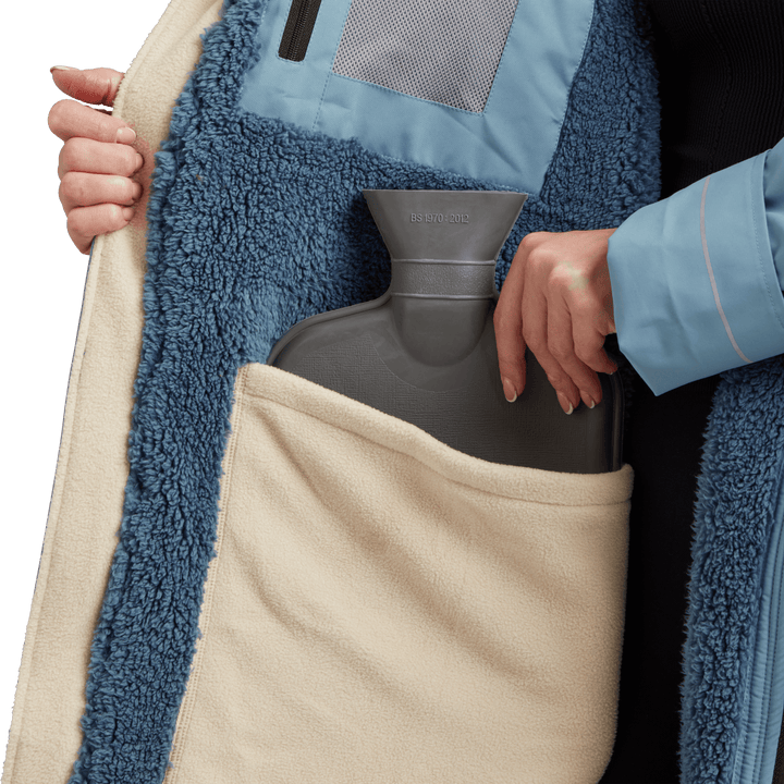 Large inside stash pocket, big enough to hold a hot water bottle, on Red Alter Evo women’s long sleeve waterproof changing robe in Alpine Blue.