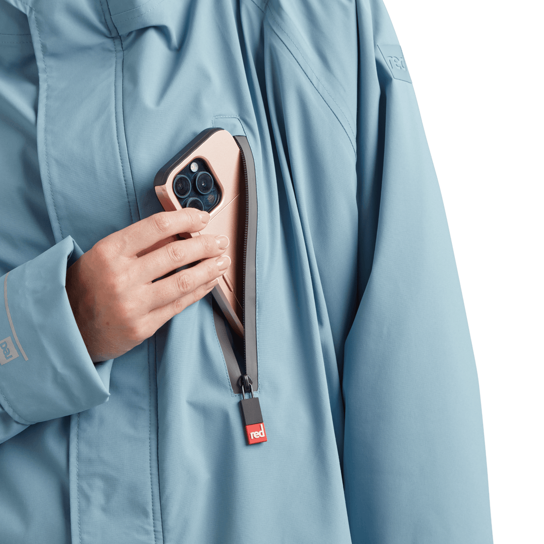 Waterproof chest pocket on Red Alter Evo women’s long sleeve waterproof changing robe in Alpine Blue, ideal for storing your mobile phone.