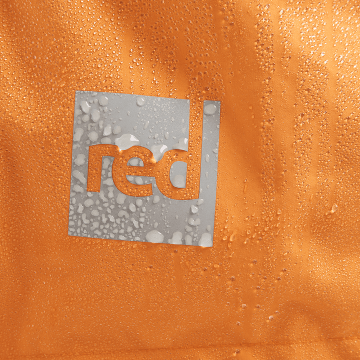 Red Equipment logo detail on Alter Evo women’s long sleeve waterproof changing robe in Bitter Orange.