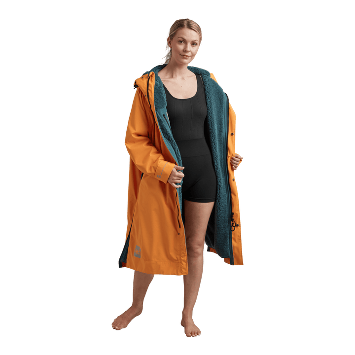 Interior view of Red Alter Evo women’s long sleeve waterproof changing robe in Bitter Orange showing the teal Sherpa fleece lining.