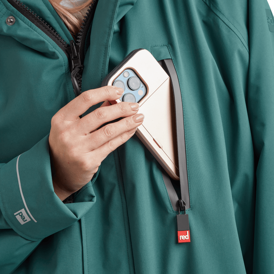 Waterproof chest pocket on Red Alter Evo women’s long sleeve waterproof changing robe in Deep Teal,  ideal for storing your mobile phone.