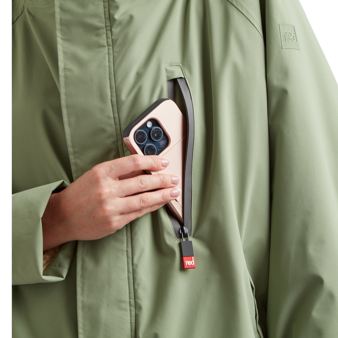Waterproof chest pocket on Red Alter Evo women’s long sleeve waterproof changing robe in Sage Green, ideal for storing your mobile phone.