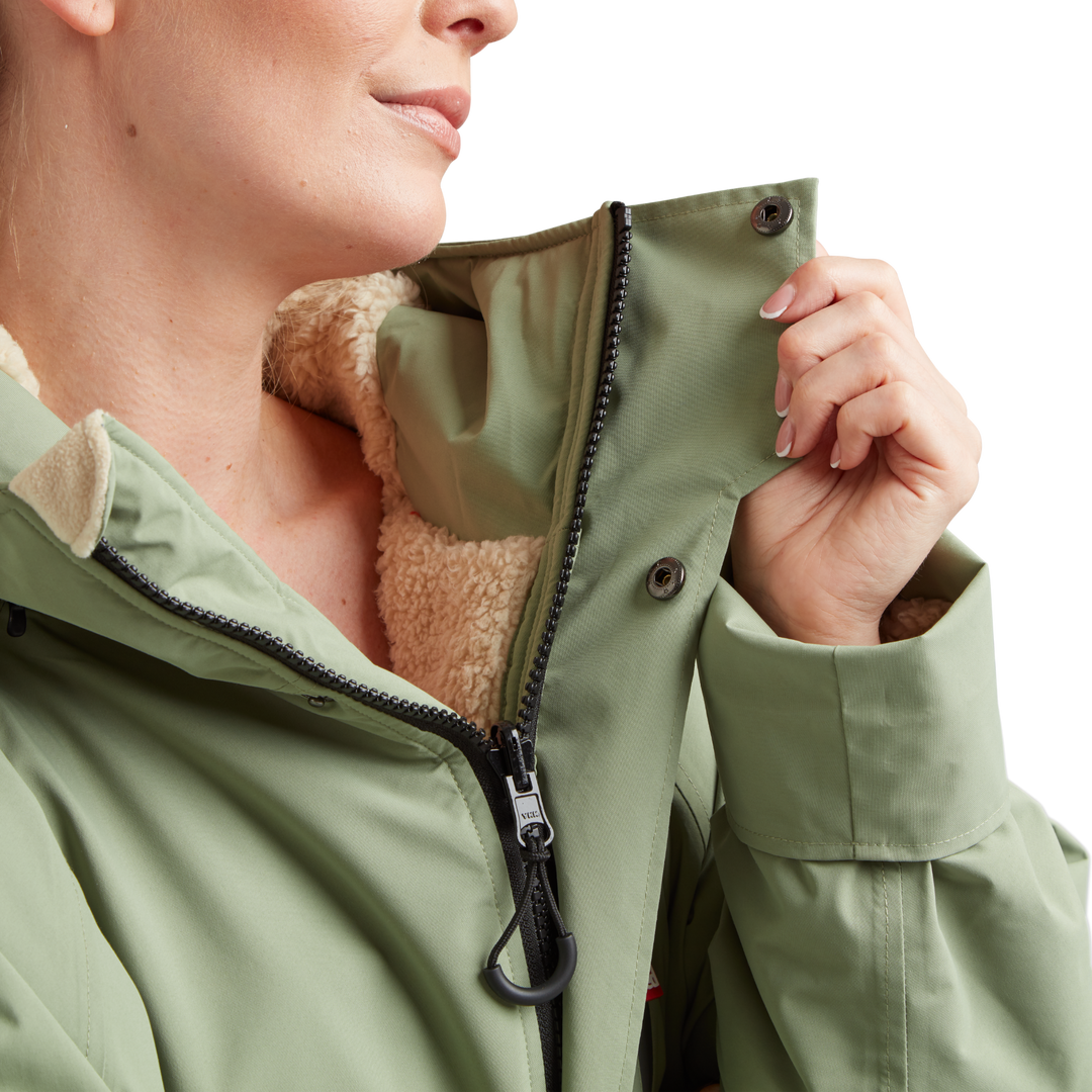Two-way YKK zip with with easy-hold pulls and guard on Red Alter Evo women’s long sleeve waterproof changing robe in Sage Green.