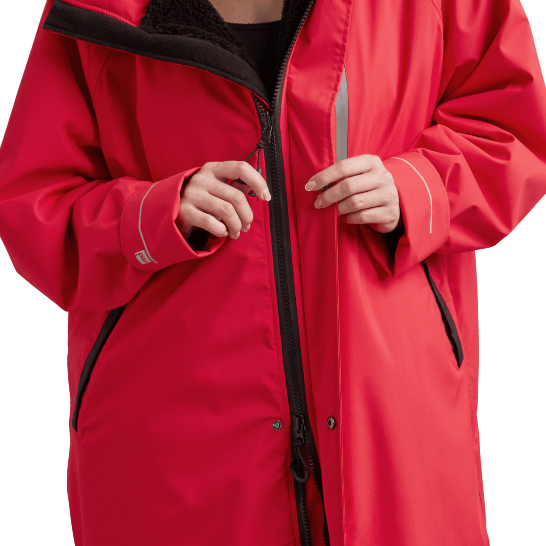 YKK two-way zip with easy-hold pulls on Red Alter Evo women’s long sleeve waterproof changing robe in Siren Red.