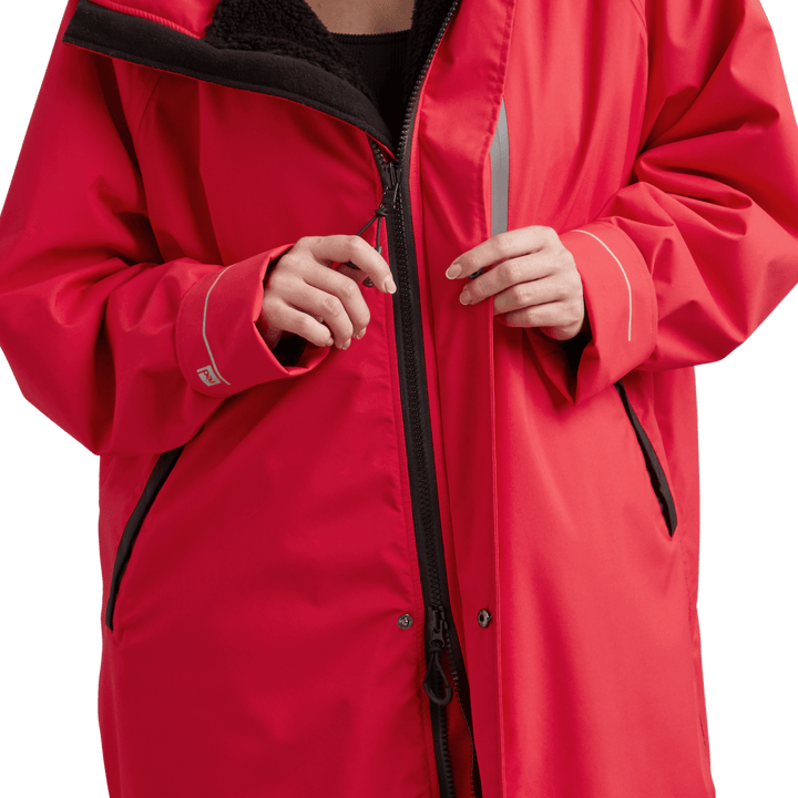 YKK two-way zip with easy-hold pulls on Red Alter Evo women’s long sleeve waterproof changing robe in Siren Red.