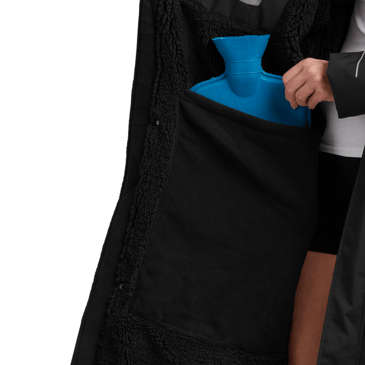 Large inside stash pocket, big enough to hold a hot water bottle, on Red Alter Evo women’s long sleeve waterproof changing robe in Stealth Black.