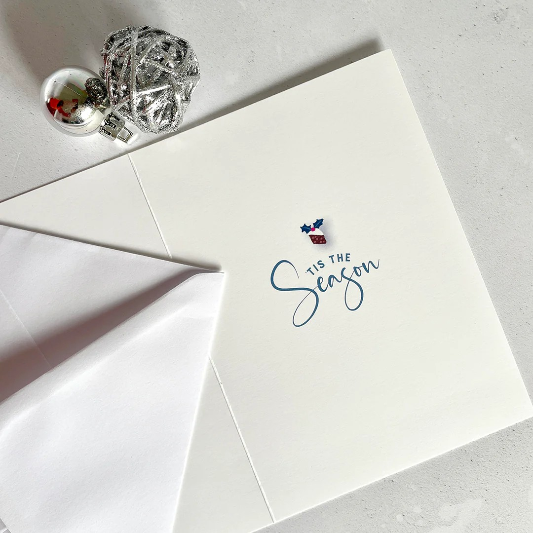 Inside view of Andrea Hall Christmas card  with ’Tis The Season’ sentiment  in elegant blue script.