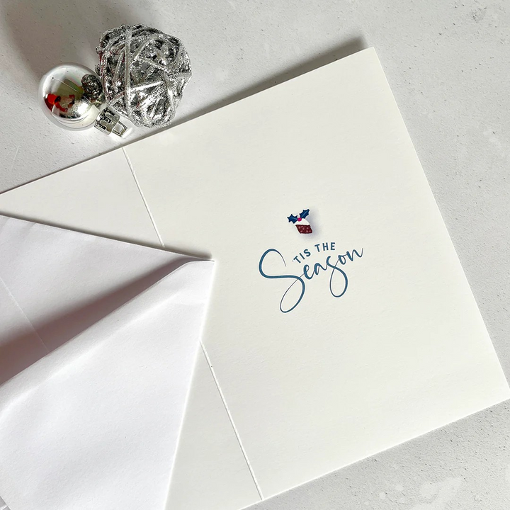 Inside view of Andrea Hall Christmas card  with ’Tis The Season’ sentiment  in elegant blue script.