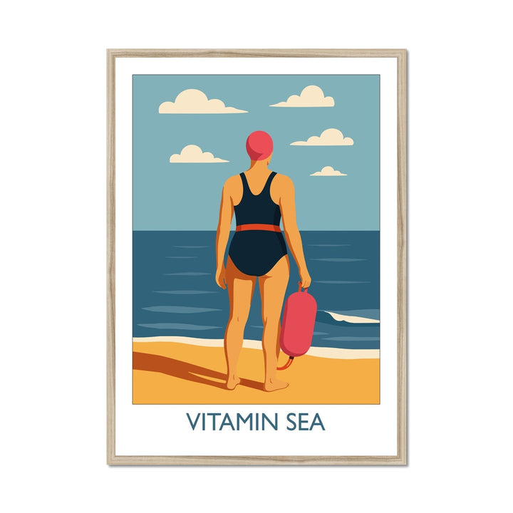Framed wild swimming art print in natural frame featuring a swimmer holding a tow float at the shoreline, titled Vitamin Sea