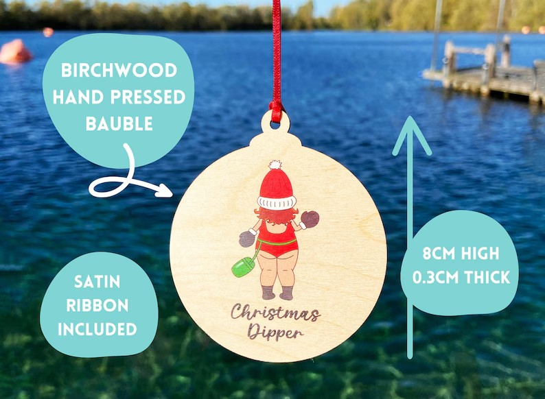 Birchwood Christmas bauble with wild swimmer design, red satin ribbon, and the text 'Christmas Dipper' - quirky festive gift for swimmers.