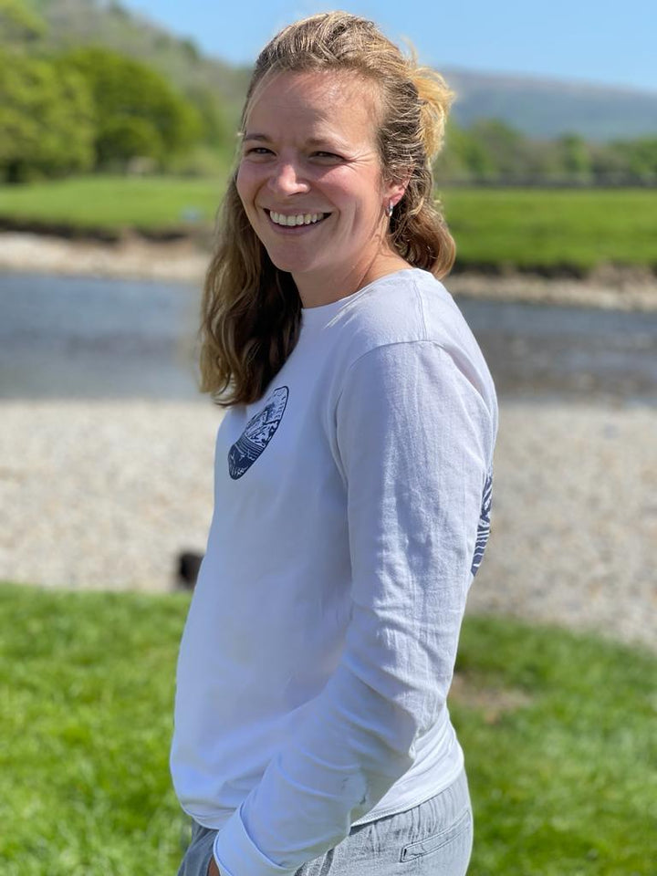 Side view of the Hannah Hunter Kelm white long-sleeve t-shirt with a Swim Wild & Free print based on one of Hannah's original linocuts