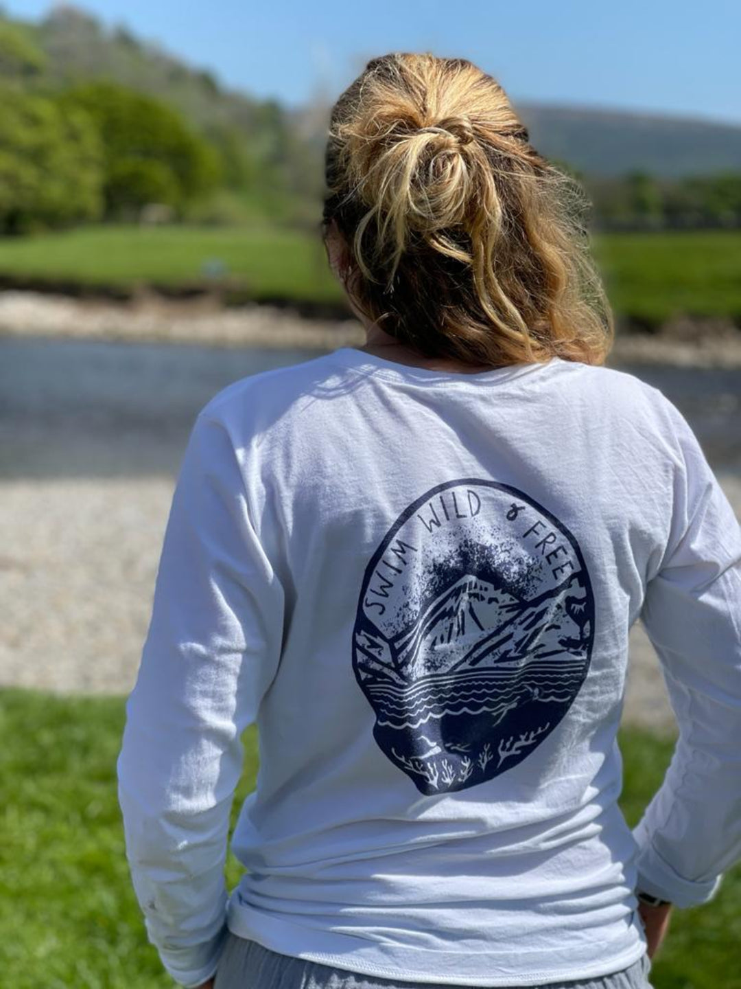 Back view of the Hannah Hunter Kelm white long-sleeve t-shirt with a print based on one of Hannah's original linocuts of a swim across Wastwater in the Lake District